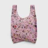 JONES + CO Standard Baggu reusable shopping bag in pink featuring a whimsical floral and castle creature print.