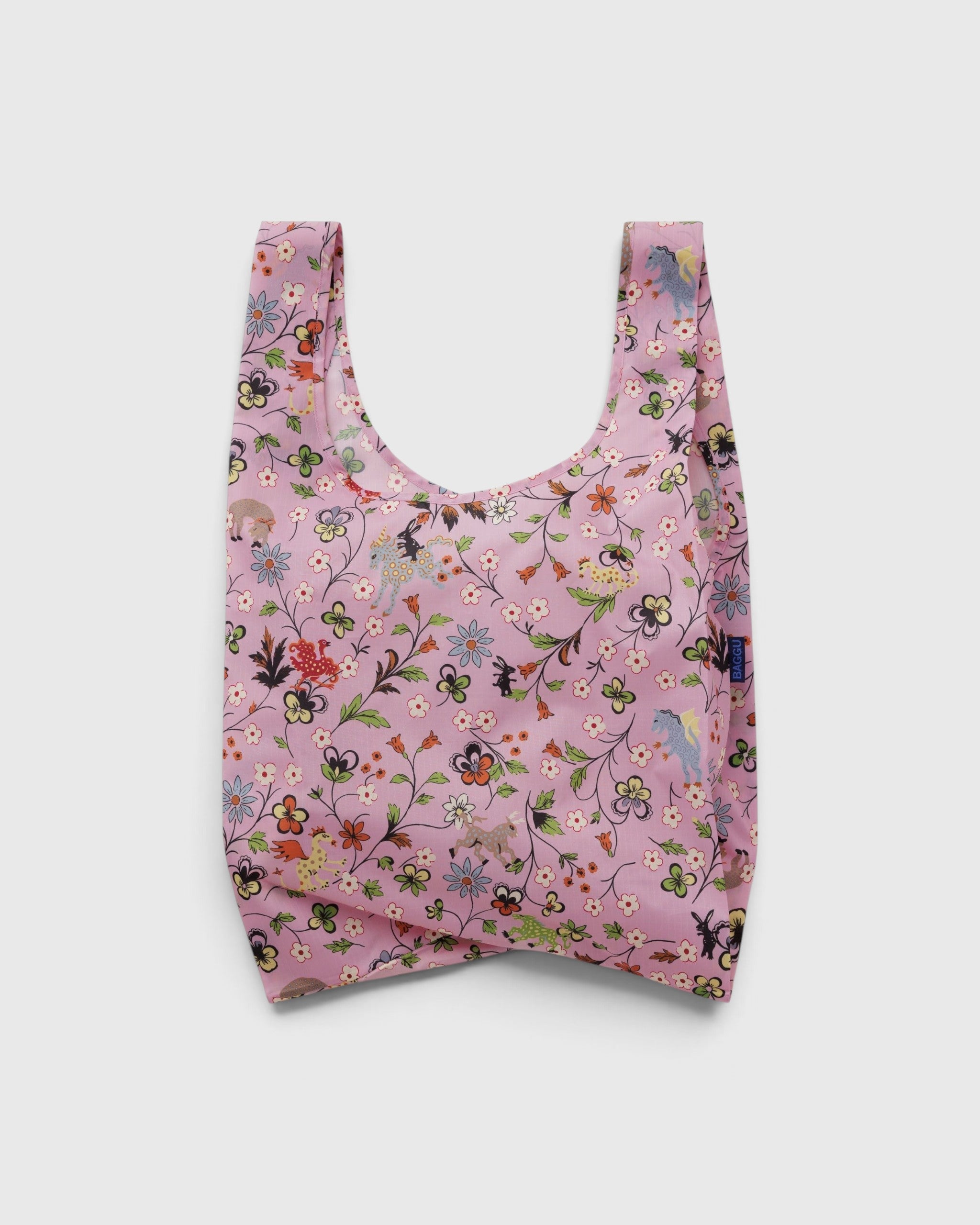 JONES + CO Standard Baggu reusable shopping bag in pink featuring a whimsical floral and castle creature print.