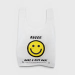 JONES + CO Baggu reusable tote in white ripstop nylon featuring a yellow smiley face and Have A Nice Day graphic