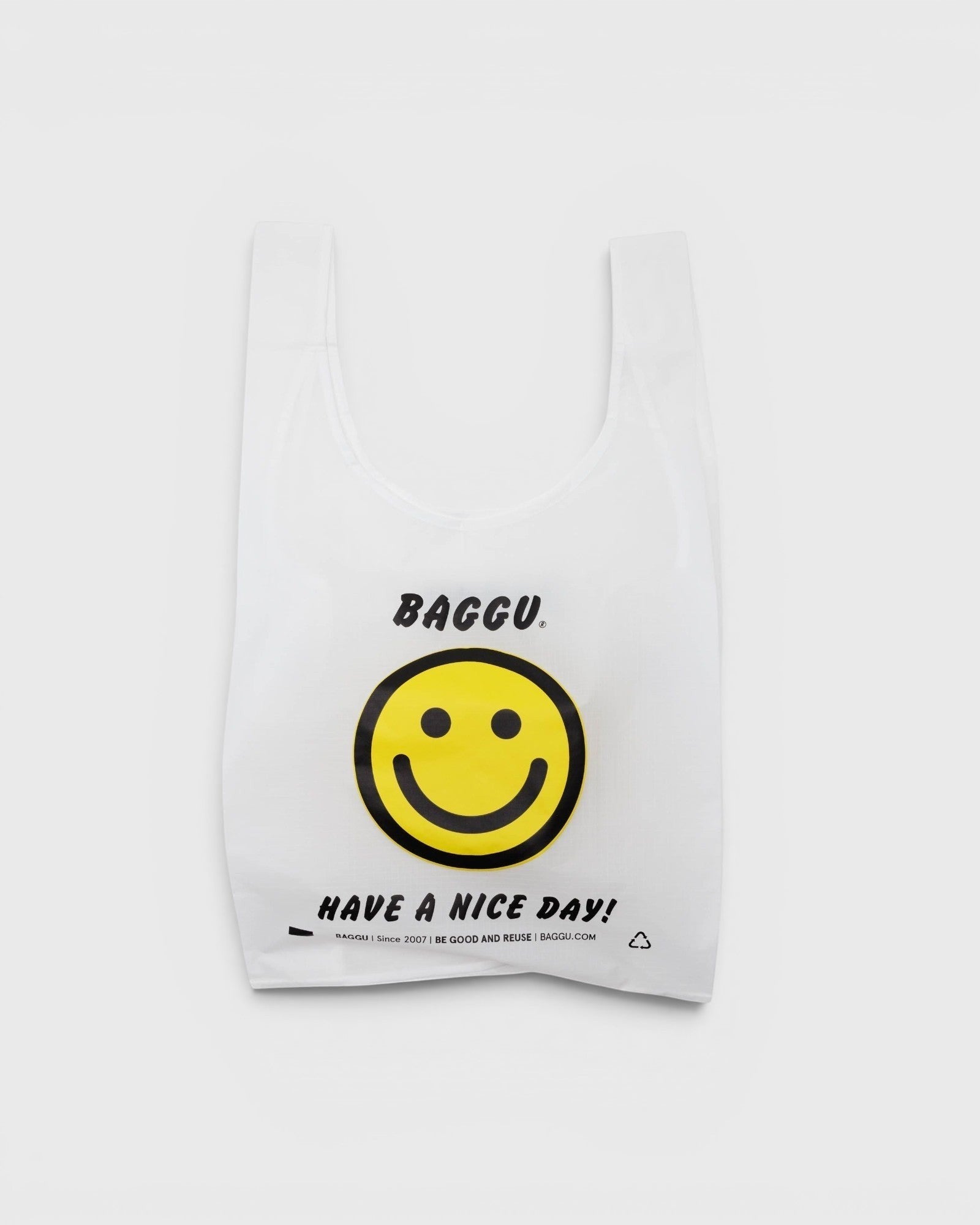 JONES + CO Baggu reusable tote in white ripstop nylon featuring a yellow smiley face and Have A Nice Day graphic
