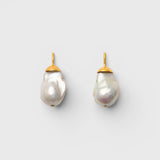 JONES + CO Go For Baroque earrings featuring large organic creamy white baroque pearls set in 14k gold over brass.