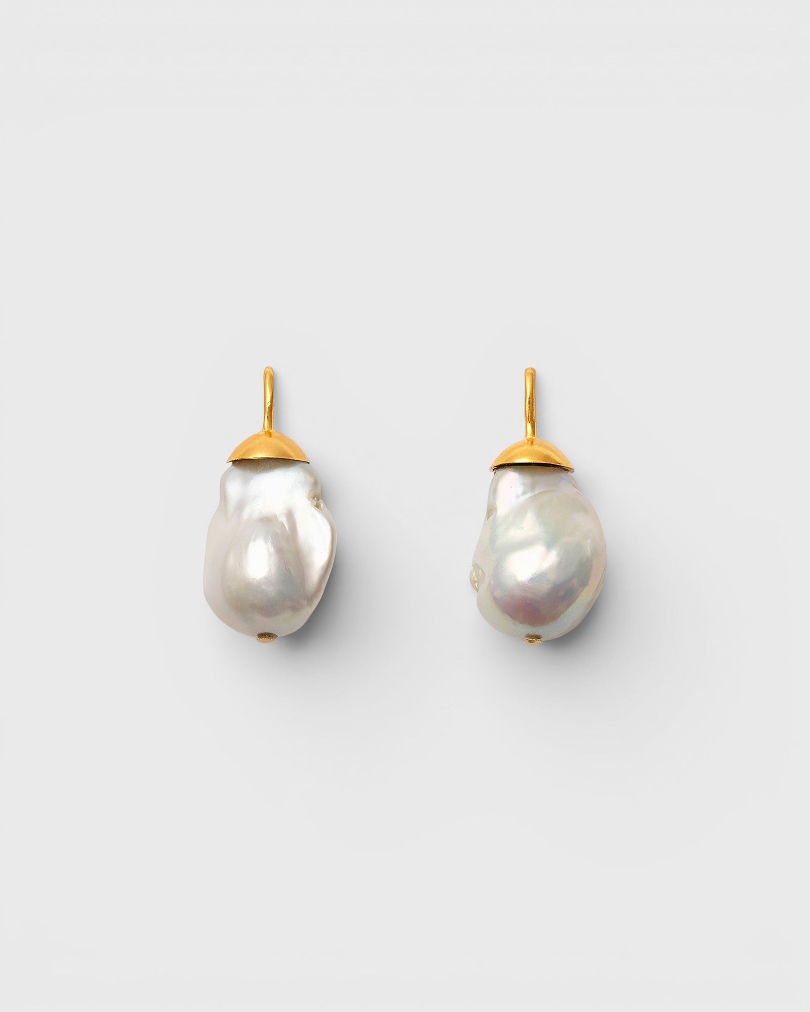 JONES + CO Go For Baroque earrings featuring large organic creamy white baroque pearls set in 14k gold over brass.