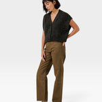 JONES + CO cropped basalt grey alpaca blend button-down vest worn by a woman with brown trousers and loafers.