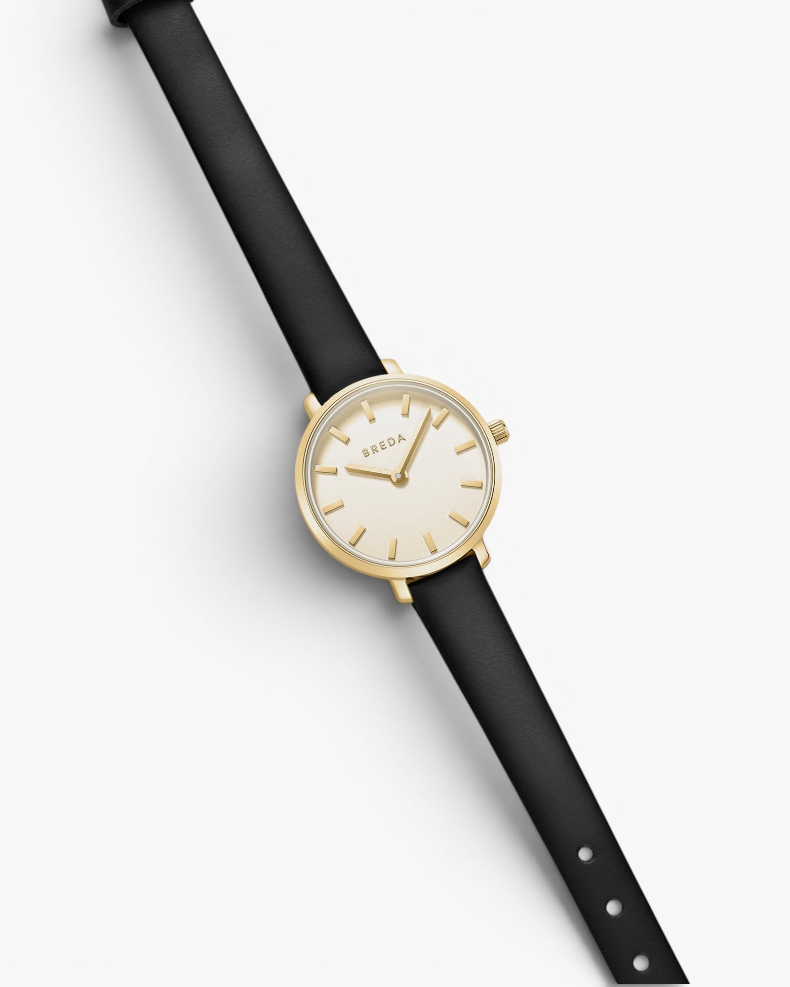 JONES + CO Beverly watch featuring a minimalist gold case, cream dial with index markers, and a black leather strap.