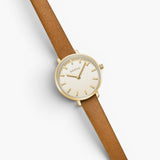 JONES + CO Beverly watch featuring a gold case, cream dial, and brown leather strap on a white background