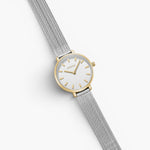 JONES + CO Beverly mesh watch featuring a silver stainless steel strap and a round gold-tone case with a white dial.