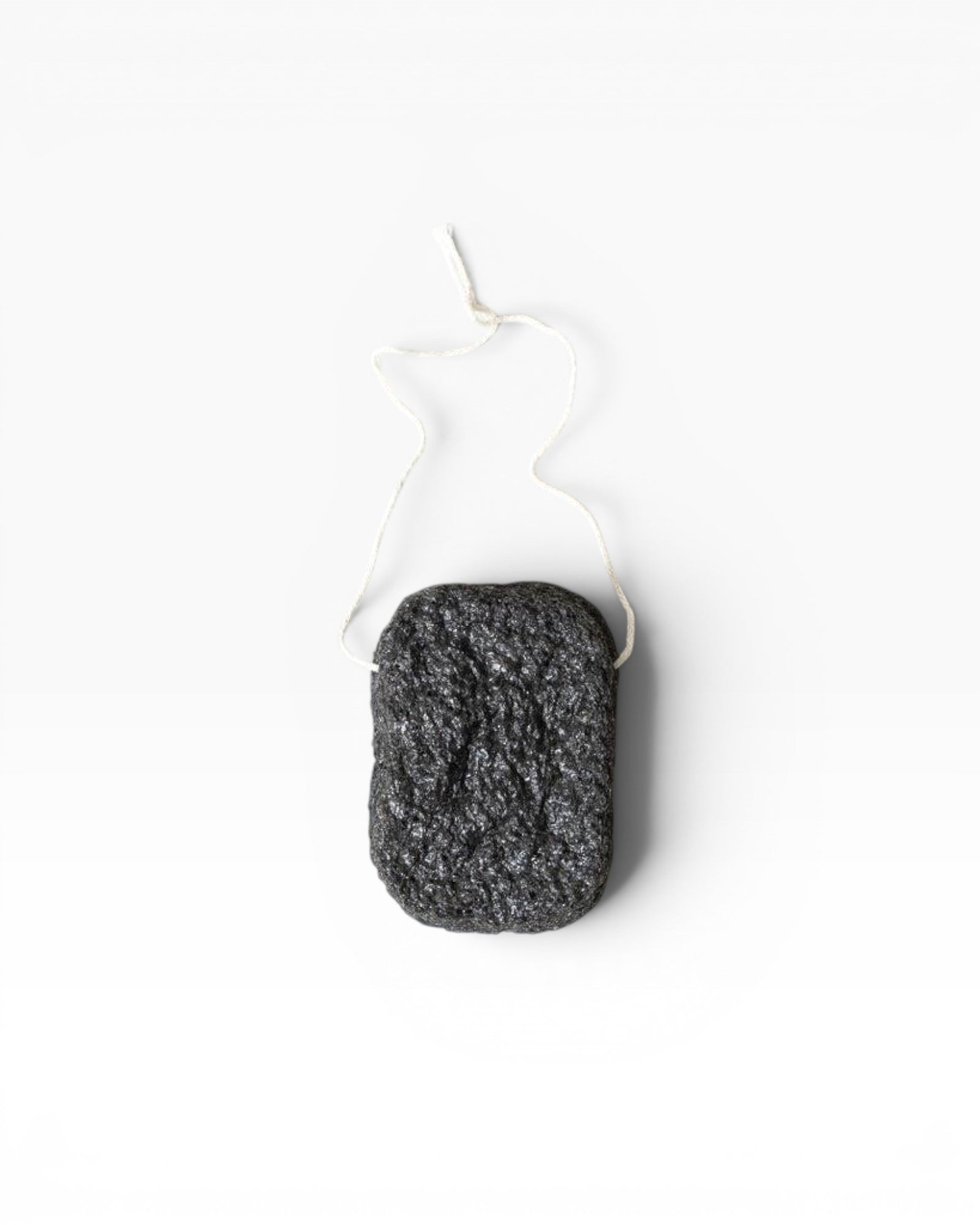 JONES + CO Binchotan charcoal facial puff made from konjac root and charcoal powder for gentle exfoliation and cleansing.