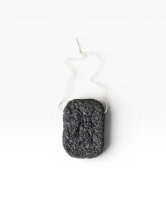 JONES + CO Binchotan charcoal facial puff made from konjac root and charcoal powder for gentle exfoliation and cleansing.