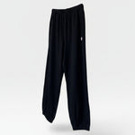 JONES + CO black heavy cotton balloon pants with elastic waistband and leg openings.