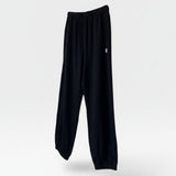 JONES + CO black heavy cotton balloon pants with elastic waistband and leg openings.