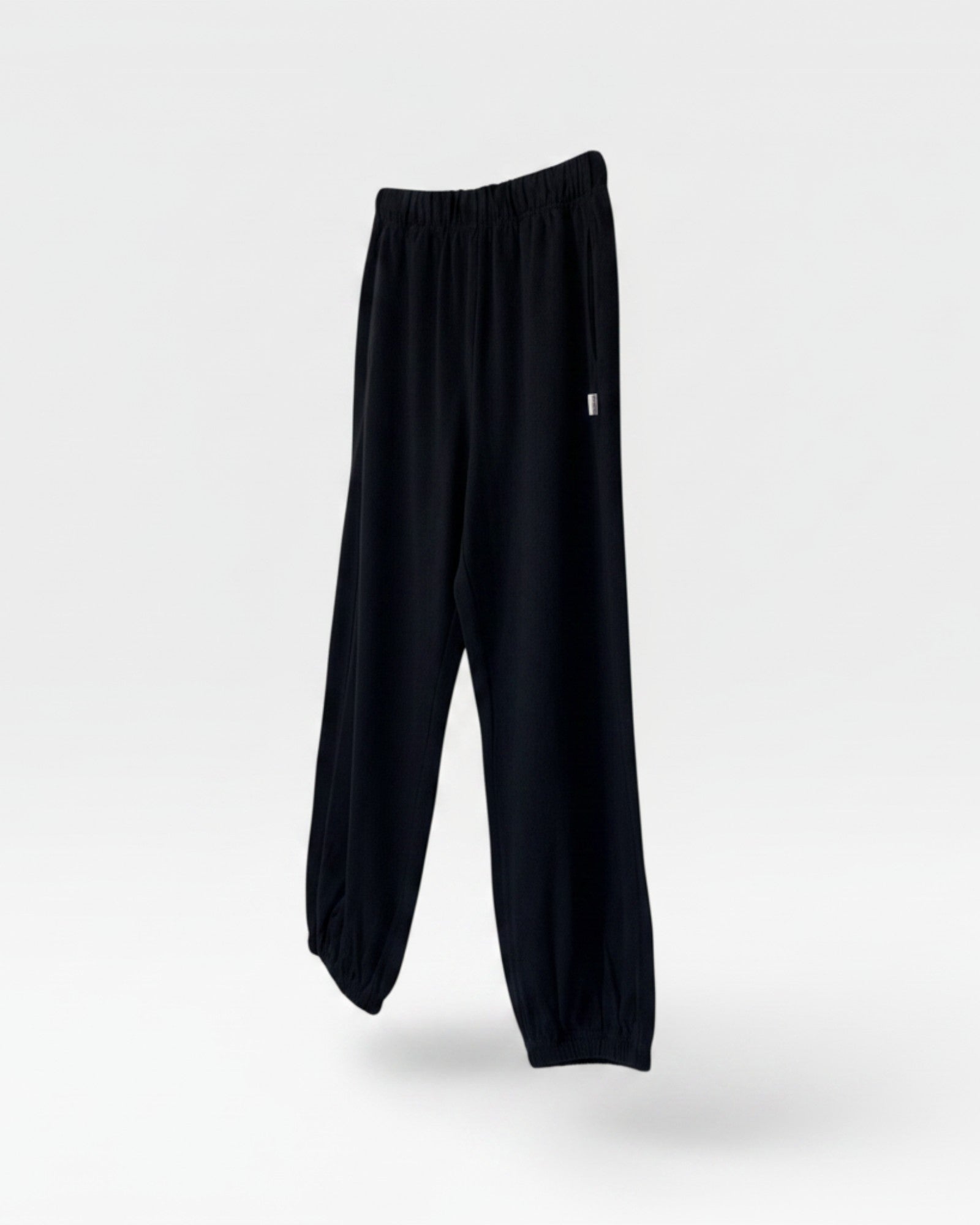 JONES + CO black heavy cotton balloon pants with elastic waistband and leg openings.