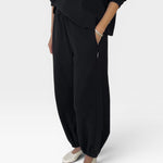 JONES + CO black heavy cotton balloon pants with elastic leg openings and side pockets.
