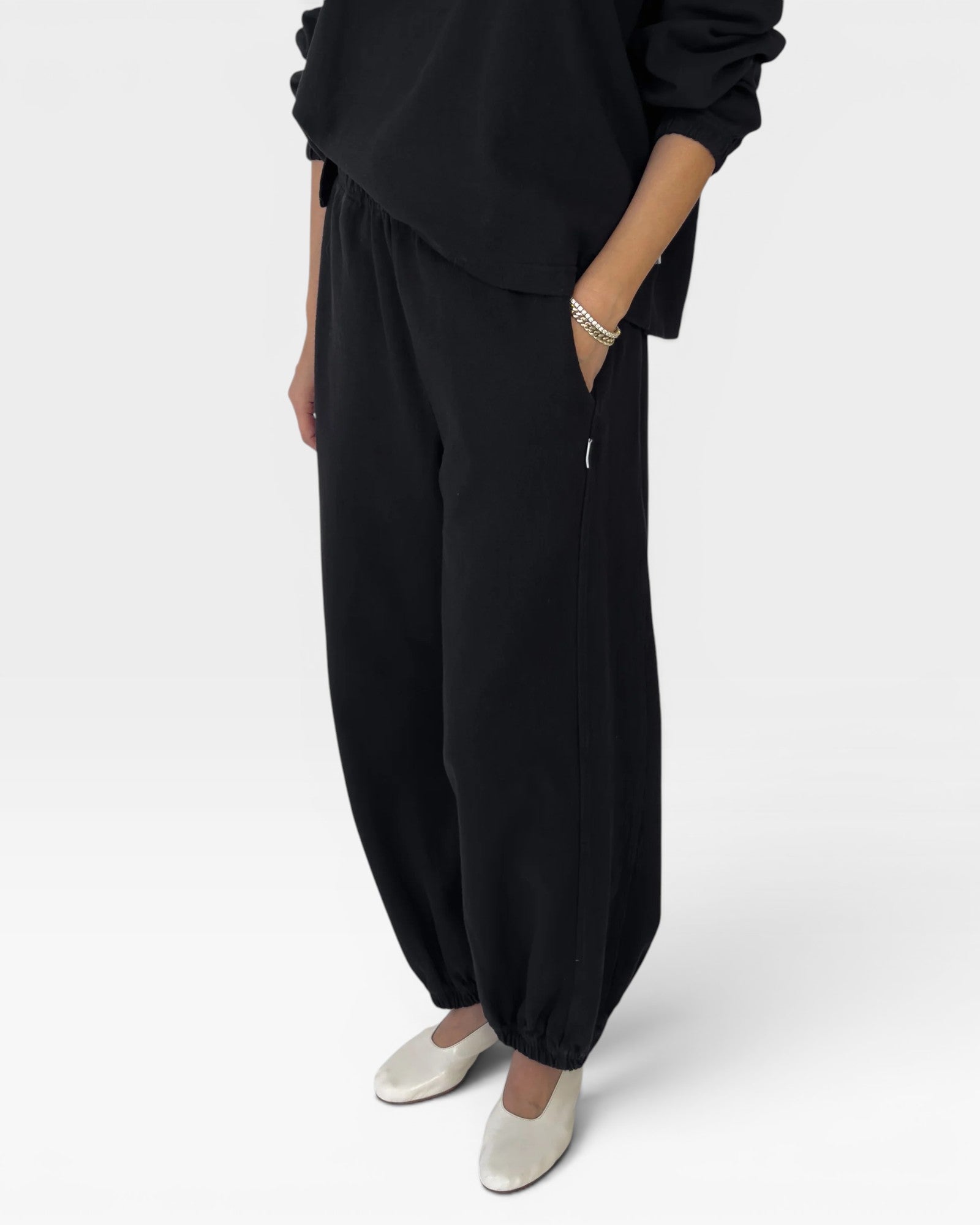 JONES + CO black heavy cotton balloon pants with elastic leg openings and side pockets.