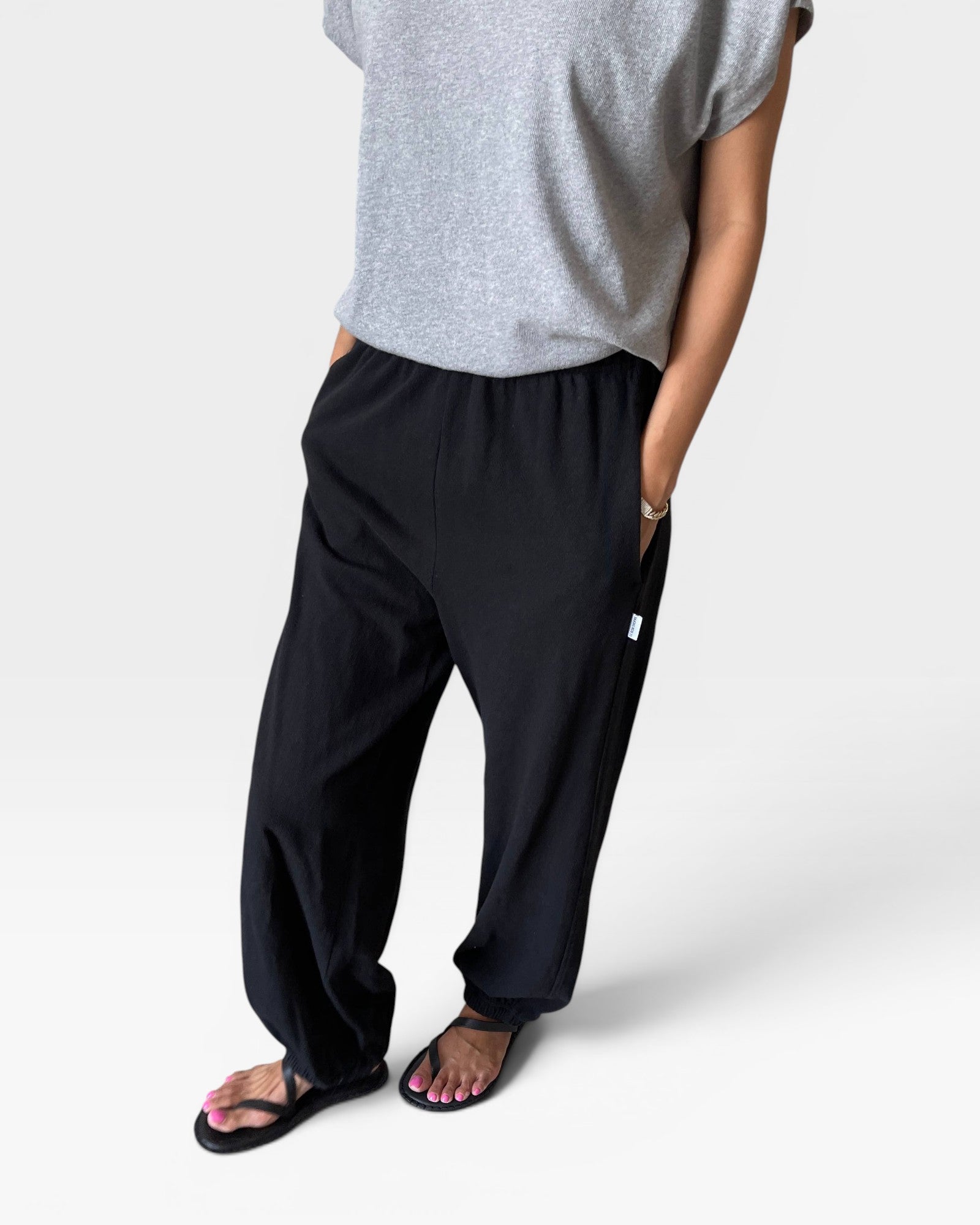 JONES + CO black heavy cotton balloon pants with elastic leg openings and side pockets.