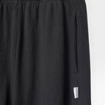 JONES + CO black heavy cotton balloon pants with elastic waistband and side pockets.