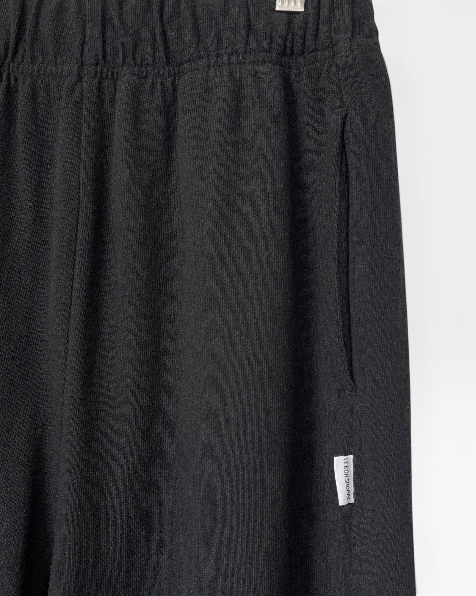 JONES + CO black heavy cotton balloon pants with elastic waistband and side pockets.