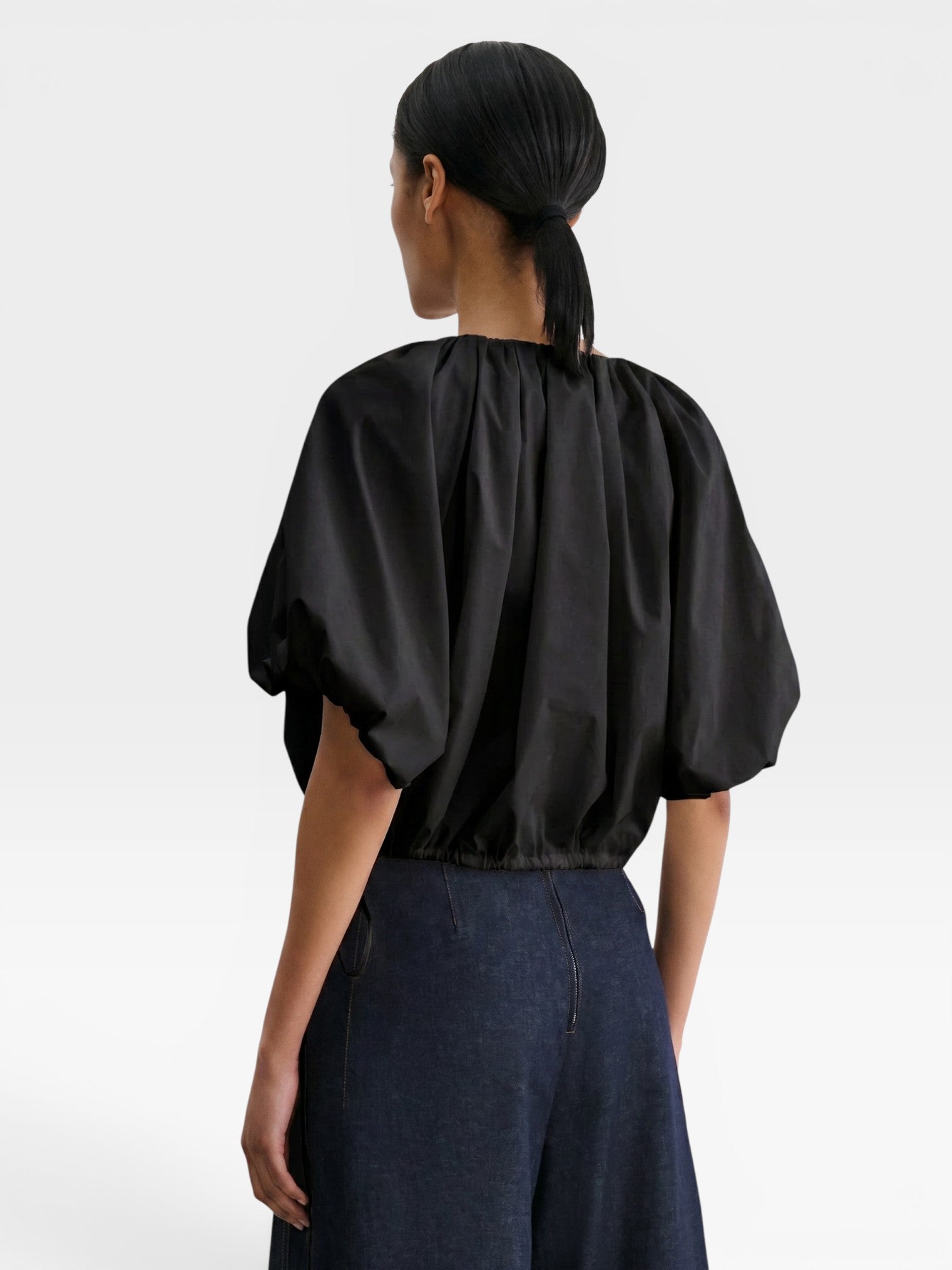 JONES + CO black cropped V-neck balloon top in organic cotton poplin with drawstring waist, back view