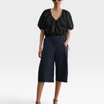 JONES + CO black organic cotton poplin cropped V-neck balloon top with adjustable drawstring waist on a model