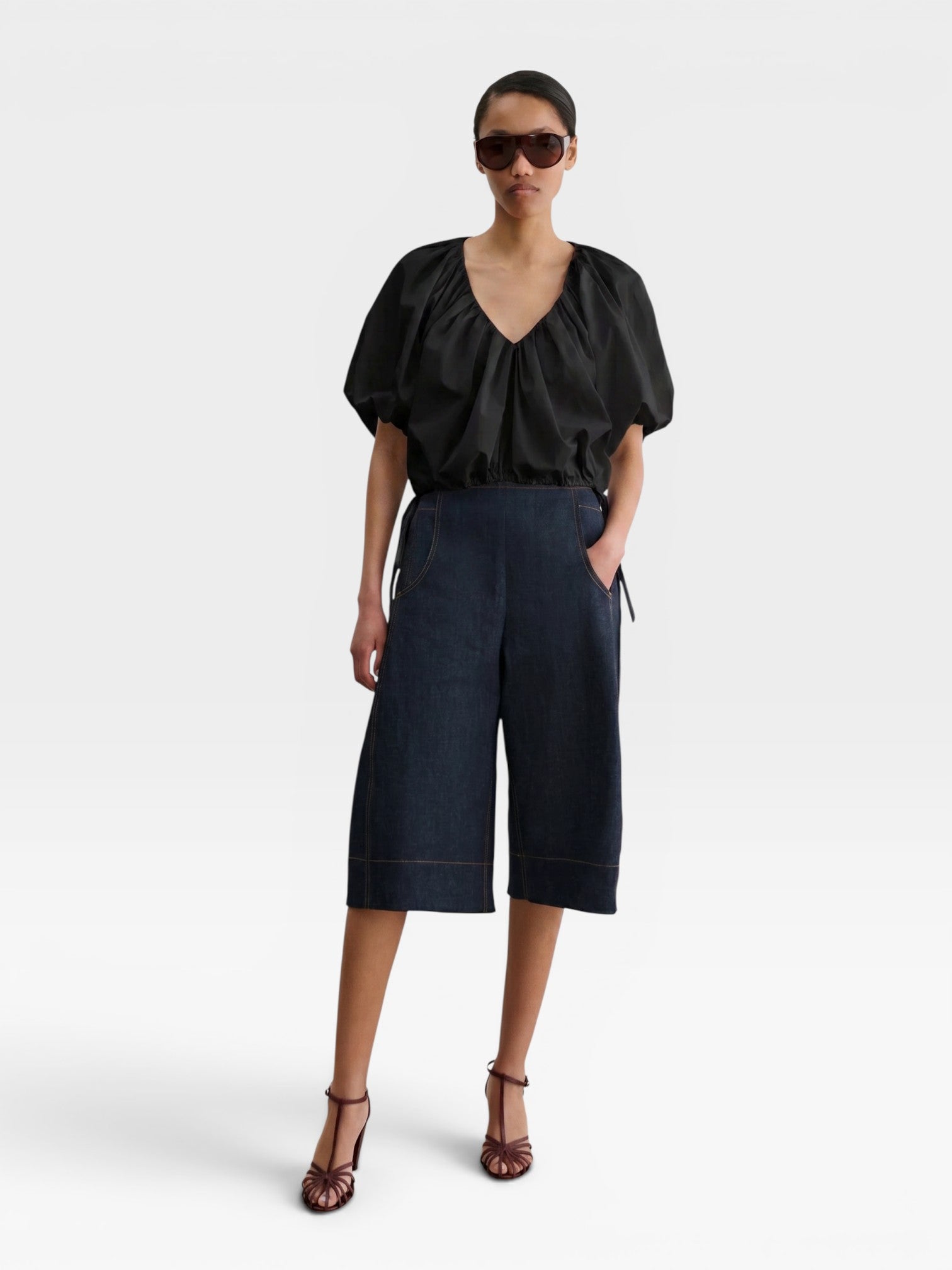 JONES + CO black organic cotton poplin cropped V-neck balloon top with adjustable drawstring waist on a model