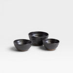 JONES + CO handcrafted black ceramic little bowls with a ribbed texture for kitchen storage or home decor.