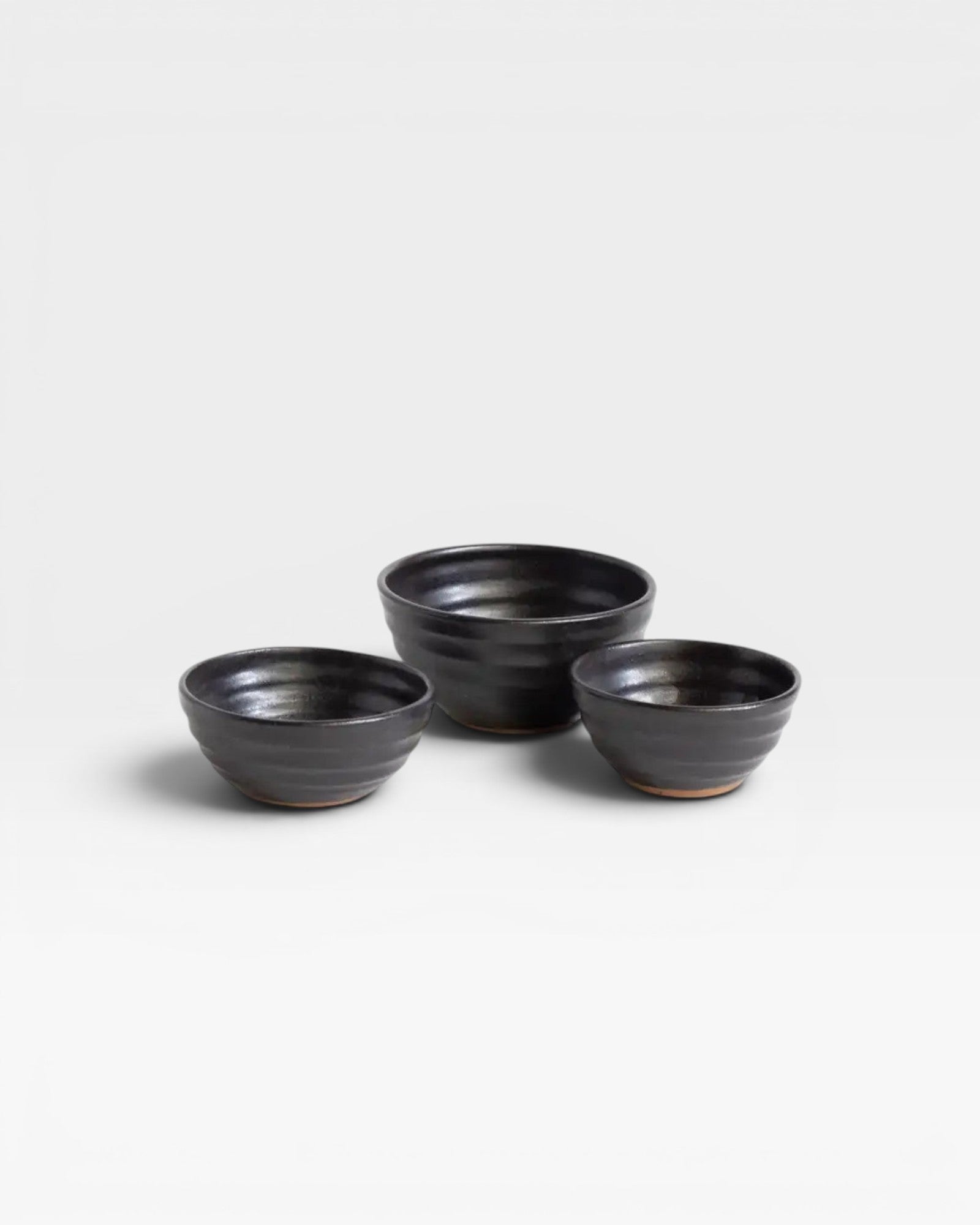 JONES + CO handcrafted black ceramic little bowls with a ribbed texture for kitchen storage or home decor.