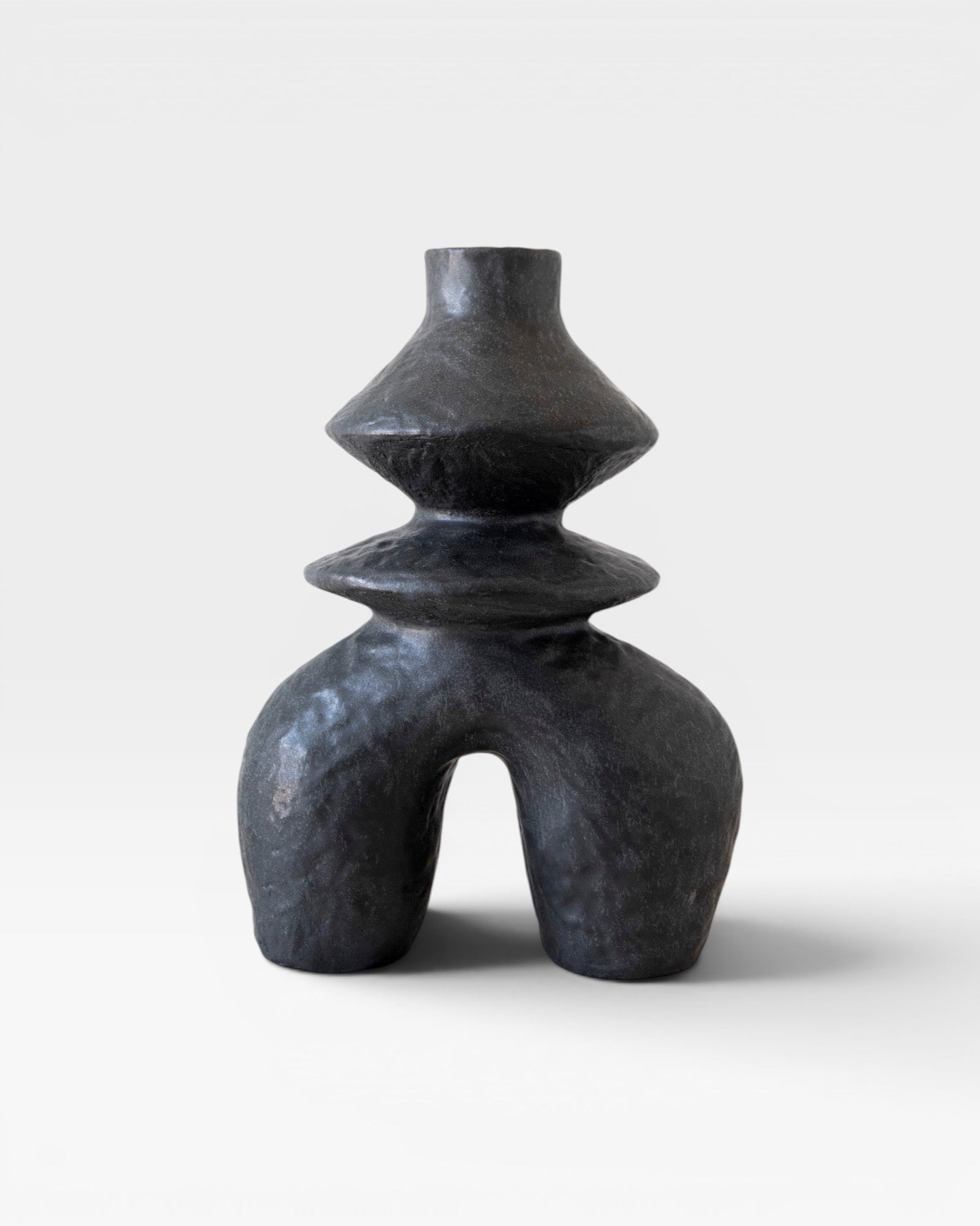 JONES + CO black ceramic vessel with a unique sculptural form and textured finish.