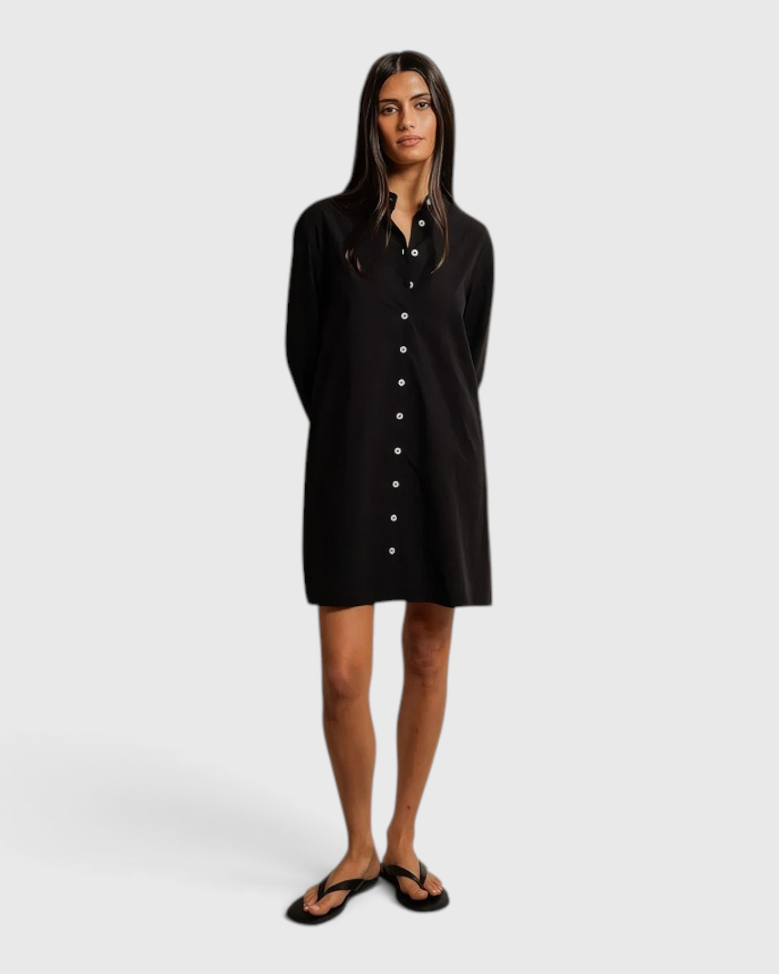 Model wearing a JONES + CO black cotton poplin shirt dress with a button-front design against a neutral backdrop.