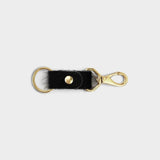 JONES + CO black cowhide keychain with gold-tone metal hardware and a secure lobster clasp