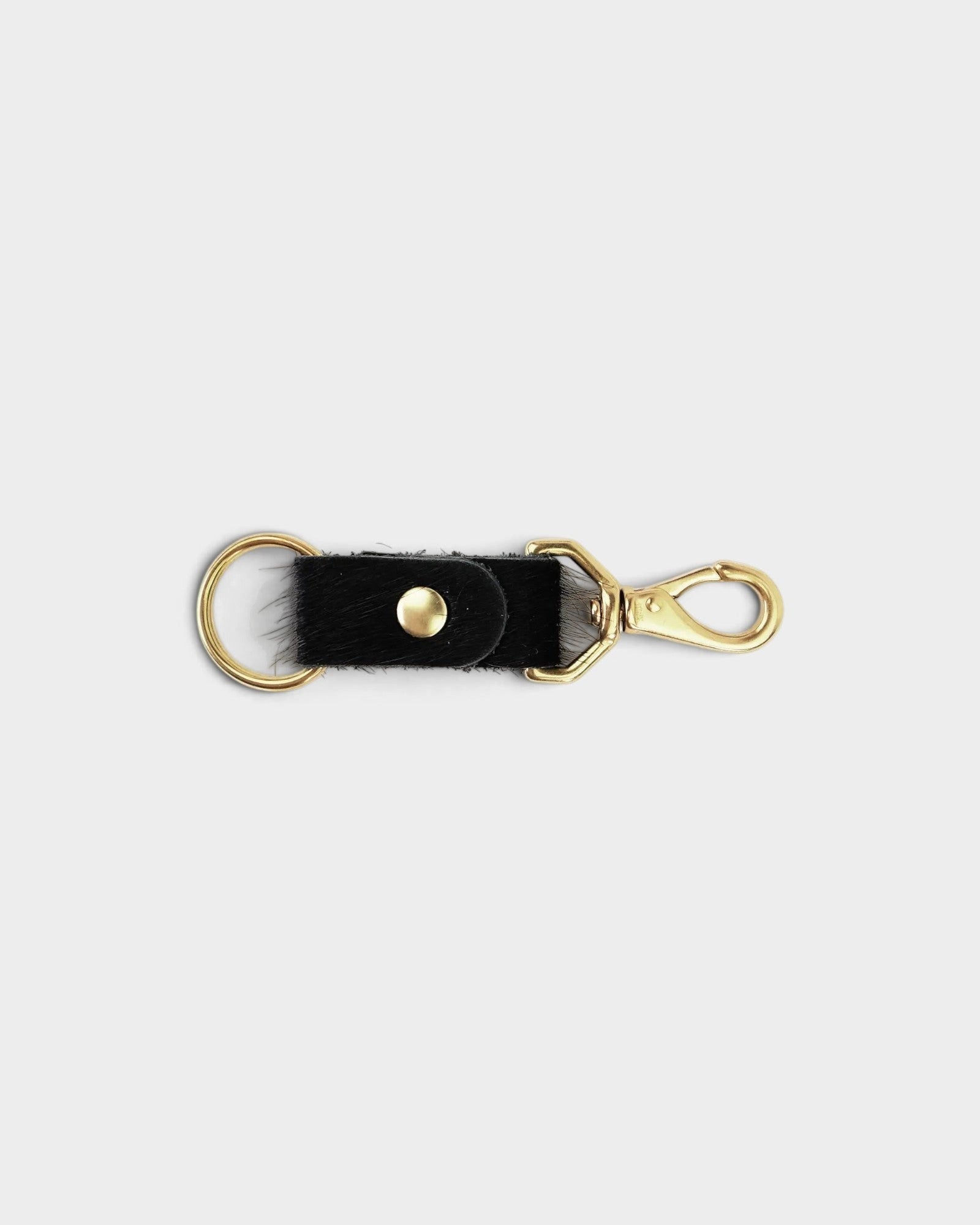 JONES + CO black cowhide keychain with gold-tone metal hardware and a secure lobster clasp