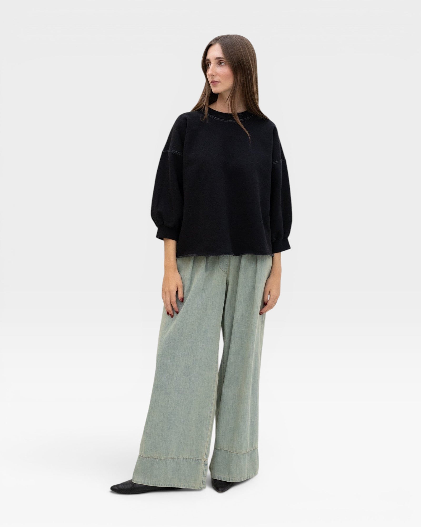JONES + CO black crewneck sweatshirt with drop shoulders, raw edge hem, and distressed details.