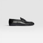 JONES + CO Sydney black crinkle patent leather penny loafer with ruched detailing on a side profile view.