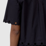 JONES + CO black cotton poplin short sleeve shirt with scalloped hem and eyelet embroidery detail