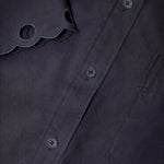 JONES + CO black cotton poplin short sleeve shirt featuring a pointed collar and intricate embroidered scalloped edge.