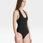 JONES + CO black halter neck bodysuit with a low scoop front and back, made from a soft, stretchy material.