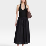 JONES + CO black halter neck bodysuit with a deep scoop neckline, paired with a black maxi skirt.
