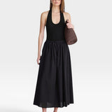JONES + CO black halter neck bodysuit with a deep scoop neckline, paired with a black maxi skirt.