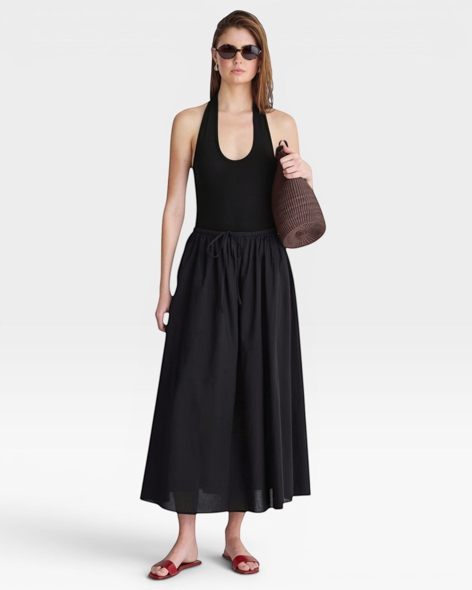 JONES + CO black halter neck bodysuit with a deep scoop neckline, paired with a black maxi skirt.