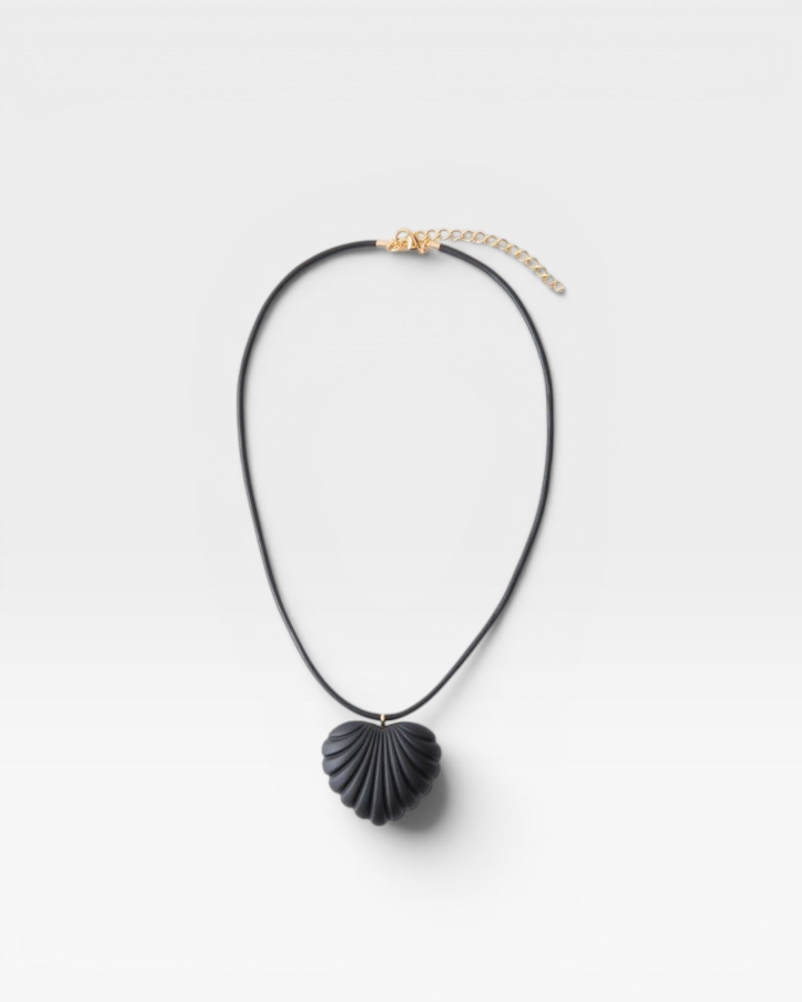 JONES + CO black acrylic shell-inspired heart pendant necklace on leather cording.