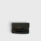 JONES + CO black leather petite card case featuring a charming knotted bow detail and slim magnetic flap closure.