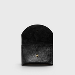 JONES + CO black leather cardholder with a rounded flap and gold snap button closure on a light grey background.