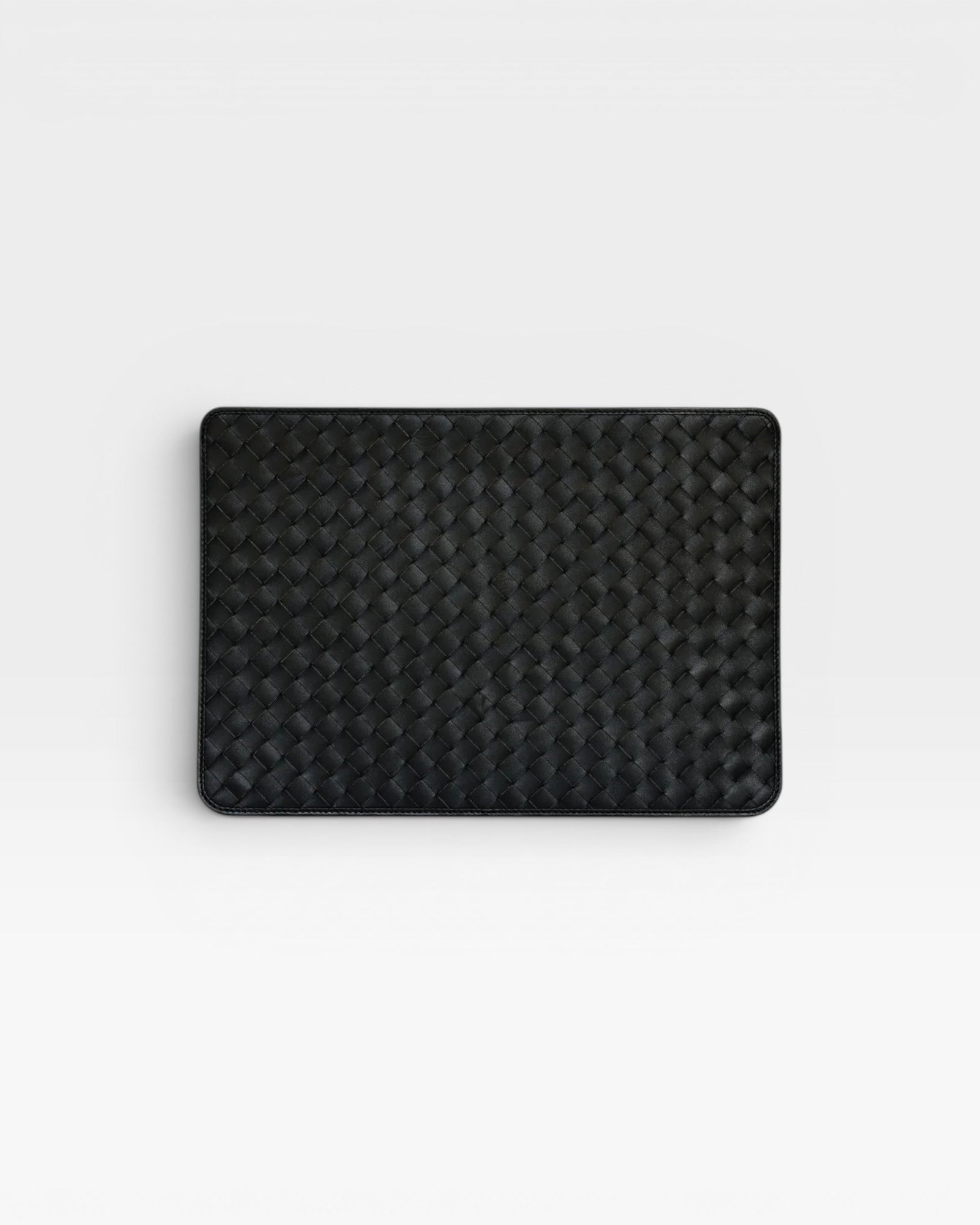 JONES + CO black leather Lia laptop case with handwoven carré detail on one side.