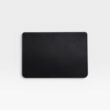 JONES + CO black leather Lia laptop sleeve with handwoven carré detail on one side.