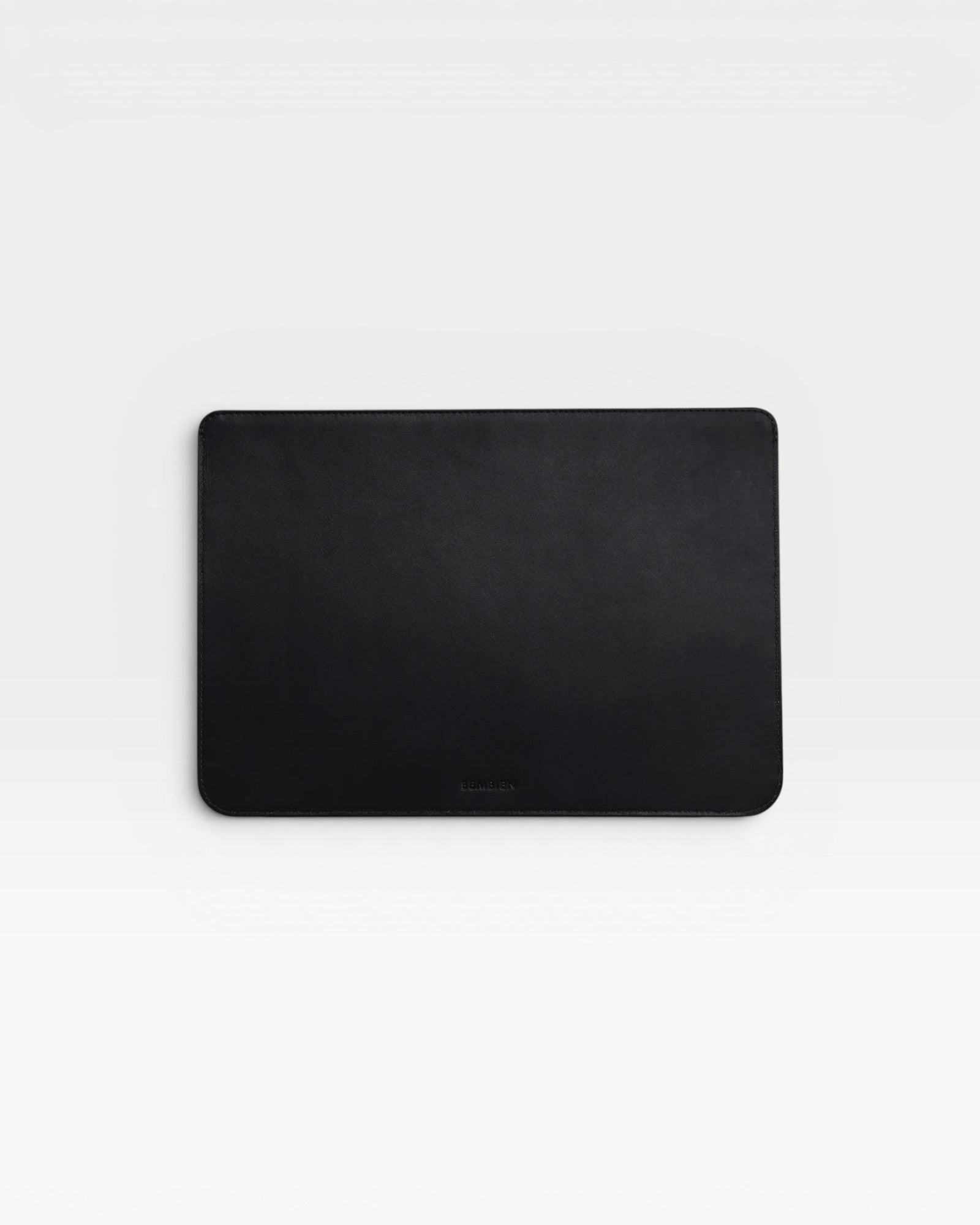JONES + CO black leather Lia laptop sleeve with handwoven carré detail on one side.