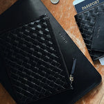 JONES + CO black leather laptop sleeve with signature handwoven carré detail and smooth leather finish.
