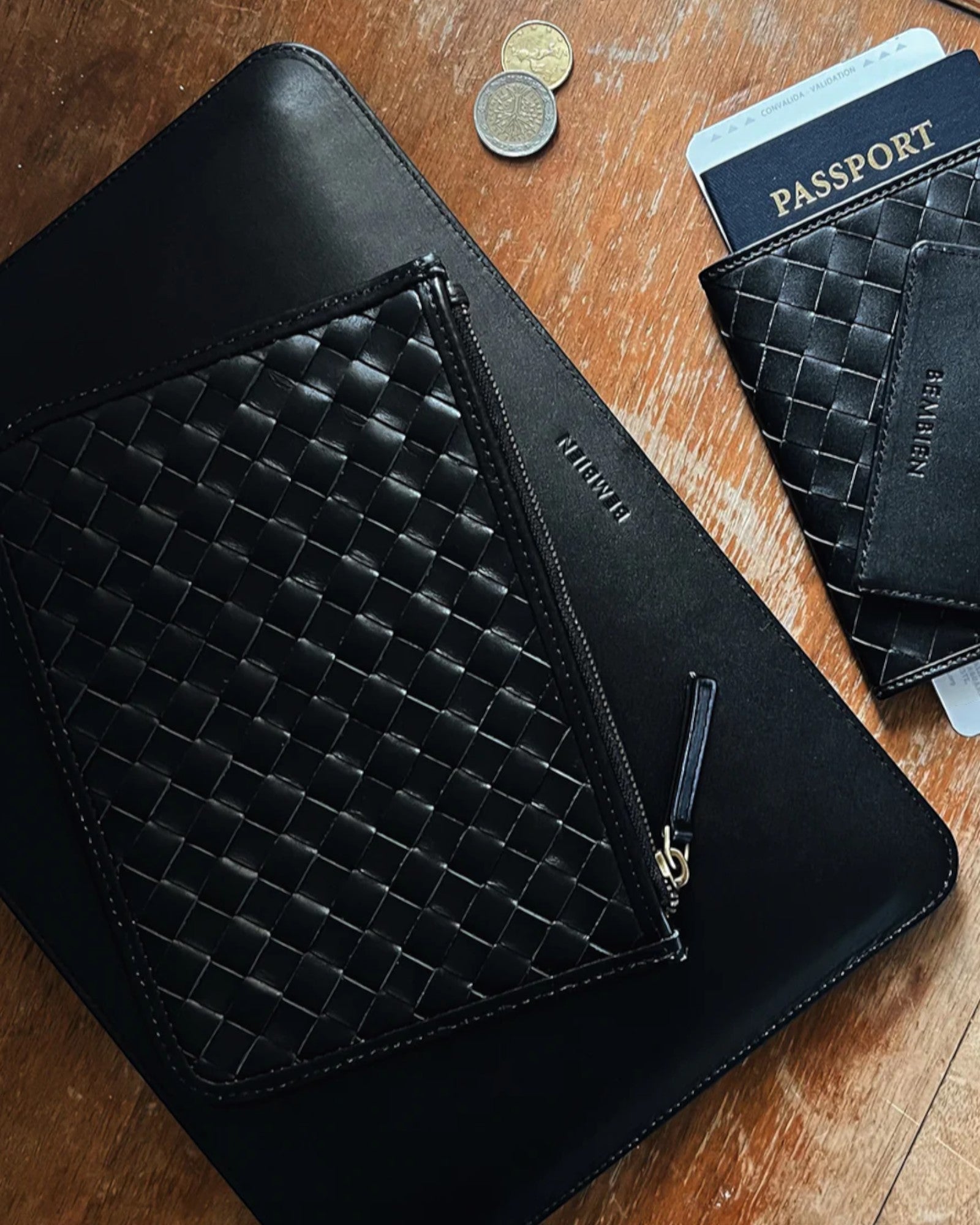 JONES + CO black leather laptop sleeve with signature handwoven carré detail and smooth leather finish.