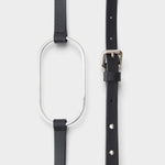 JONES + CO black leather Studded Cole Belt with a large silver oval buckle and polished metal rivet details.