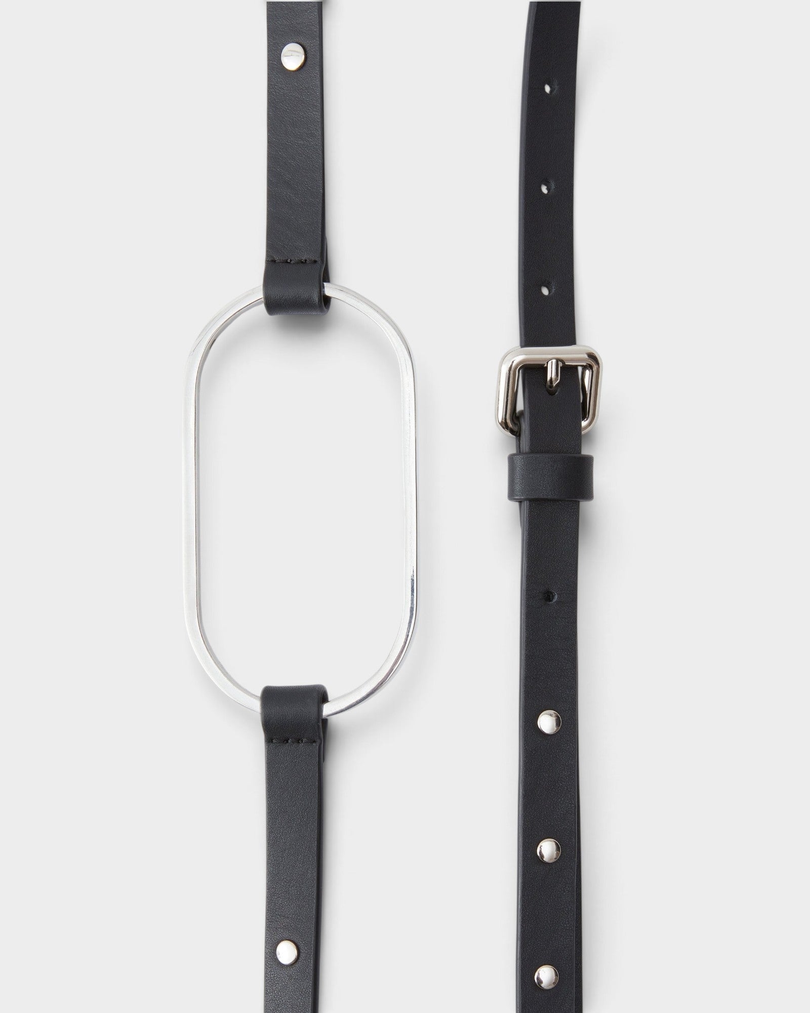JONES + CO black leather Studded Cole Belt with a large silver oval buckle and polished metal rivet details.