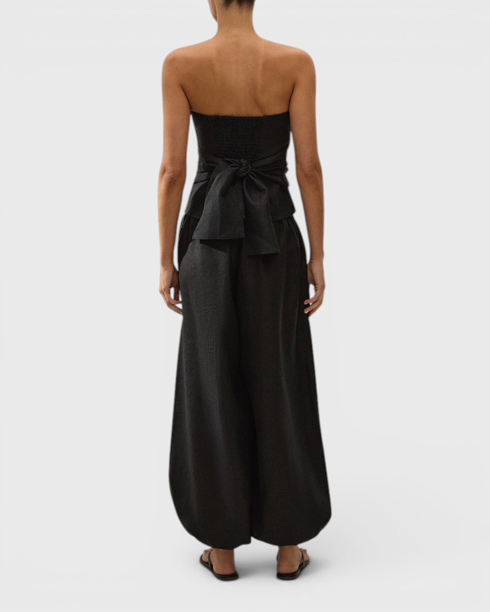 JONES + CO black linen strapless Alzira top featuring a shirred back panel and a wide tie waist detail
