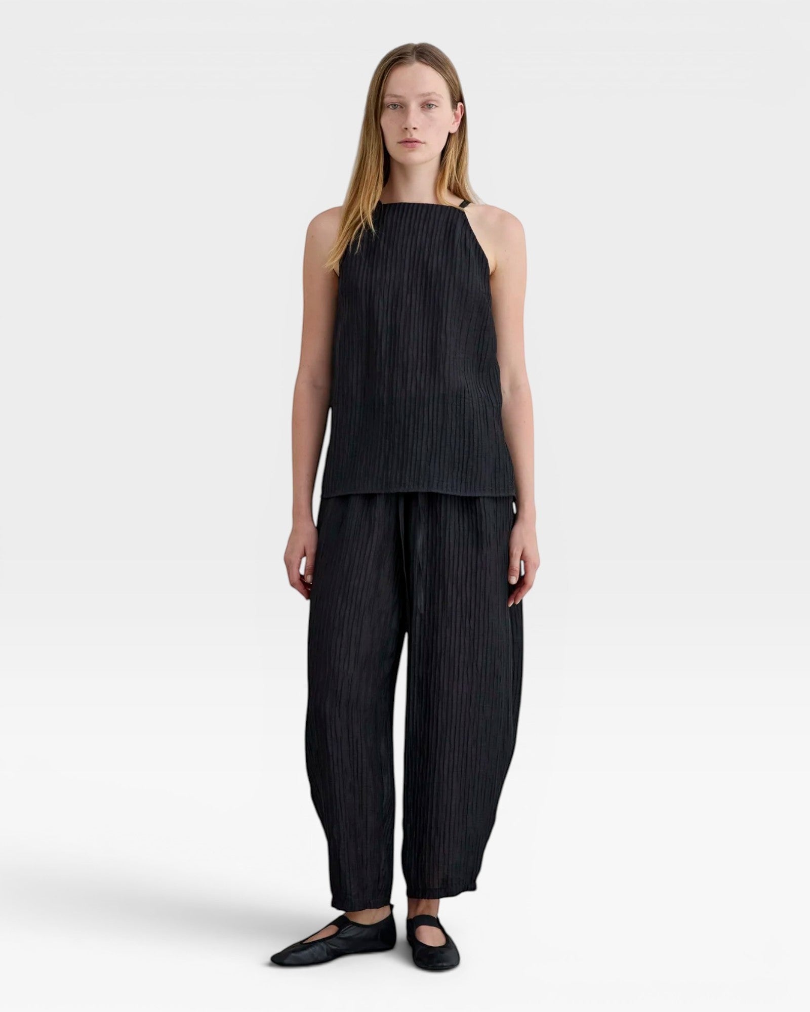 JONES + CO black Lyocell blend balloon-leg trousers with elasticated waistband and ankle buttons.