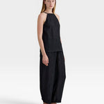JONES + CO black Lyocell blend wrinkle finish balloon-leg pull-on trousers with elasticated waistband and ankle buttons.